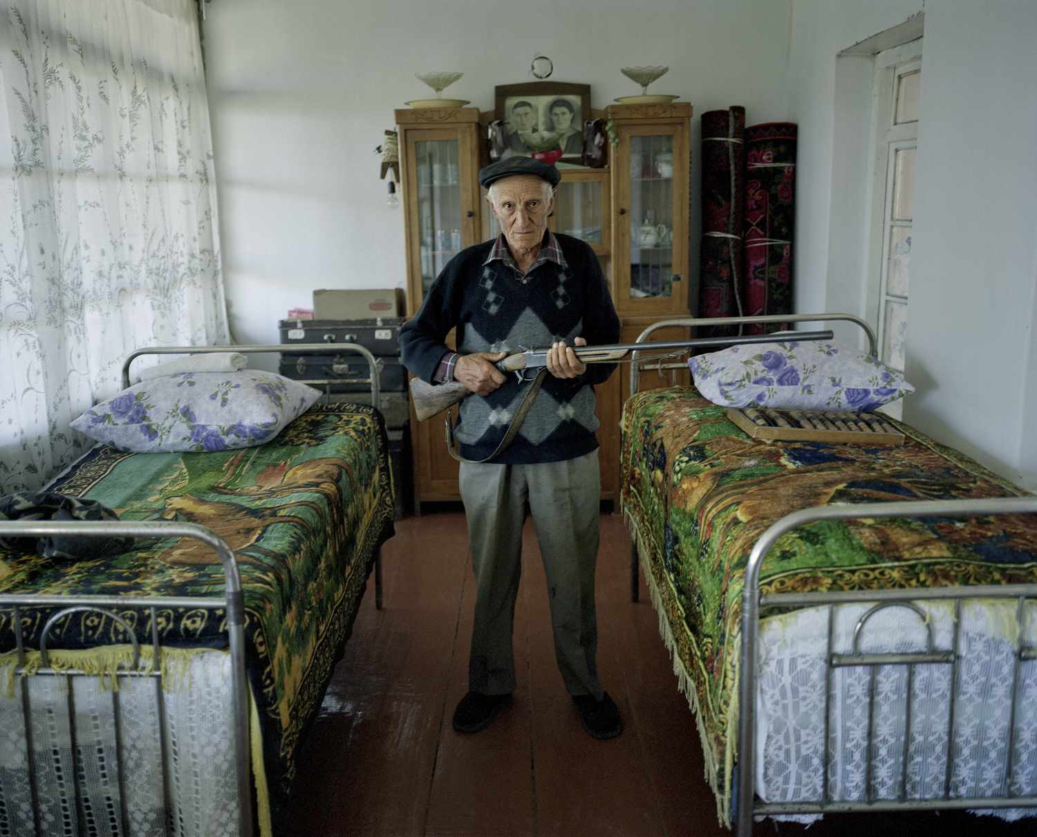 Old man, Aghasyan Aharon, village Kolatak. Guns are still a natural part of many households.
